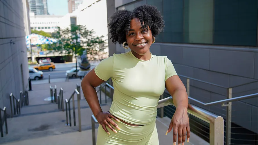A woman leaning on a stair case railing