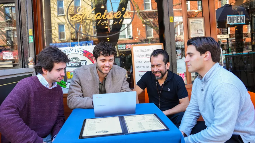 Fordham students meet with the owner of Moise Restaurant in the Bronx