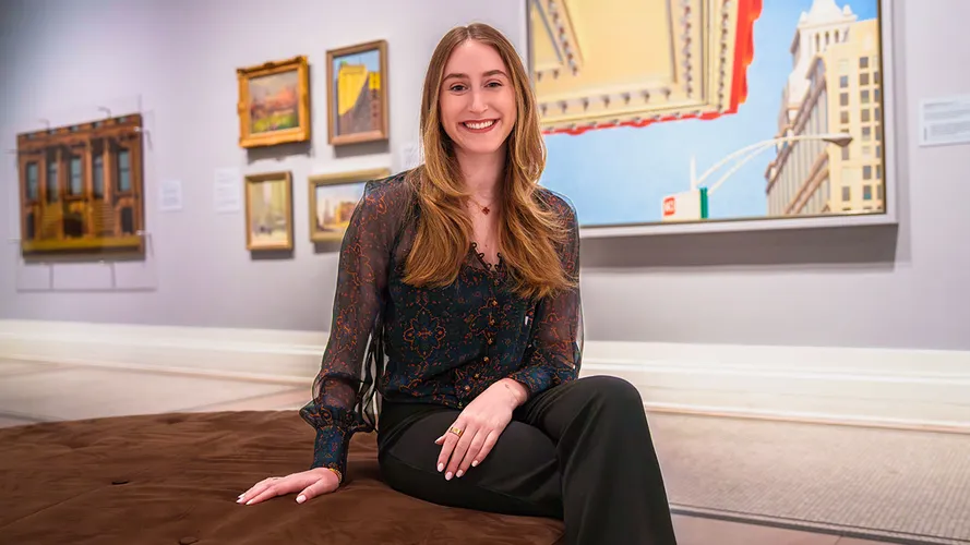 student posing inside museum