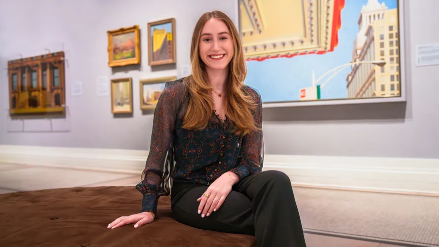 A student posing in a museum