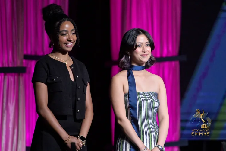 Two Fordham students stand on stage at the 46th annual News and Documentary Emmy Awards