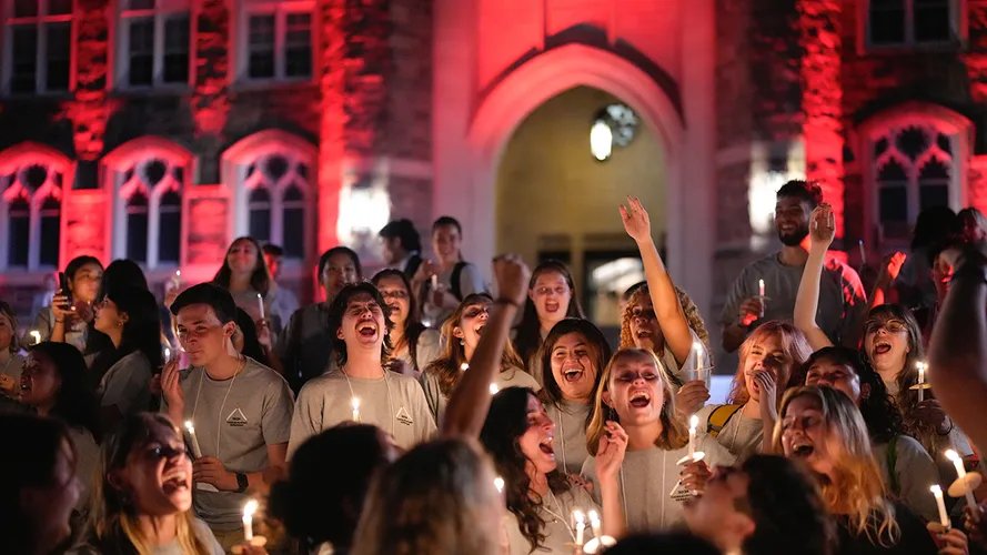Fordham students hold candles during the traditional ceremony on Edwards Parade