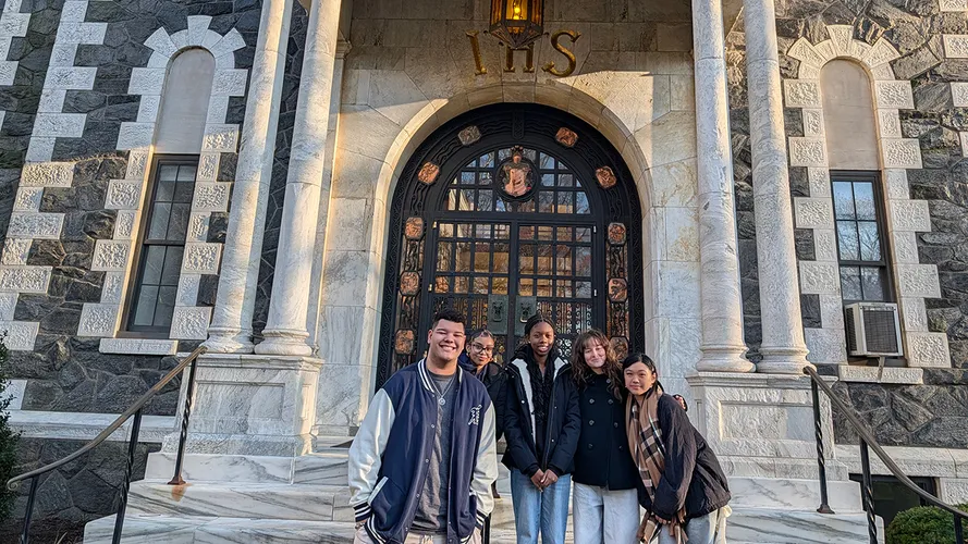 Christian Arrechea poses with local high students at Dealy Hall