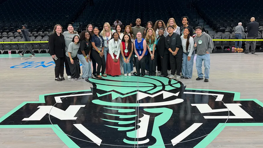 Patrick Gabriel Torres poses with his intern cohort on the floor of the Barclays Center