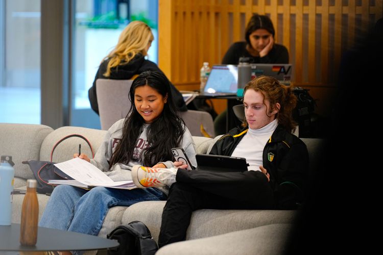 Two students study on a couch in the McShane Center at Rose Hill