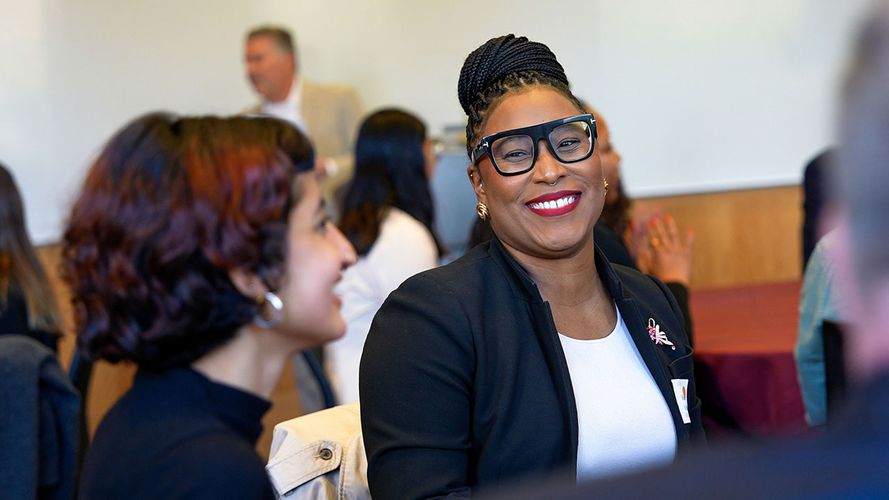 two young women talking and smiling
