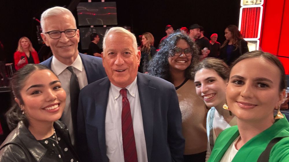 A group of students poses with Anderson Cooper and Walter Isaacson at CNN's broadcast of Good Night and Good Luck.