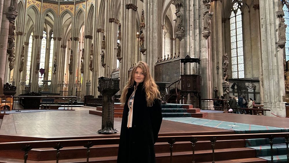 A girl poses in a historical venue in Cologne, Germany