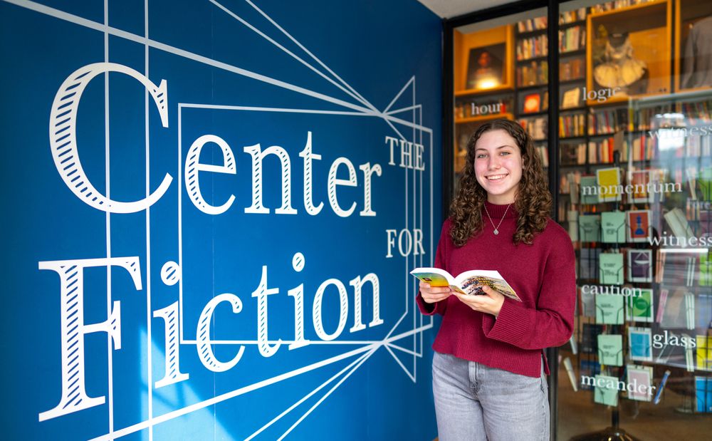 Madison Cossaboom standing in front of Center for Fiction signage