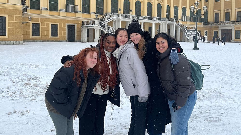 A group of friends poses in front of a building in Vienna