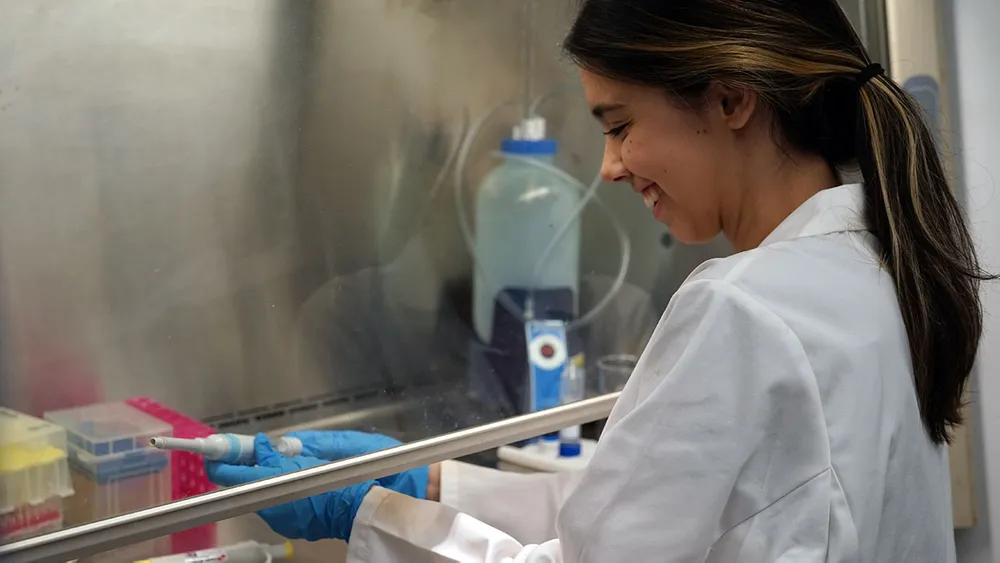 A student conducts research in a biochemistry lab