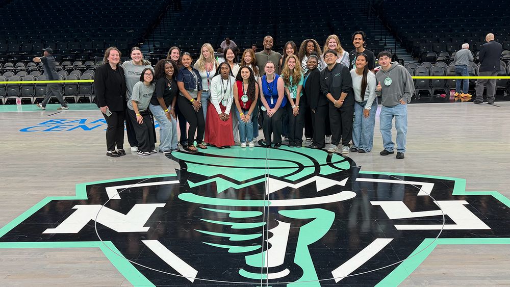 Patrick Gabriel Torres poses with his intern cohort on the floor of the Barclays Center