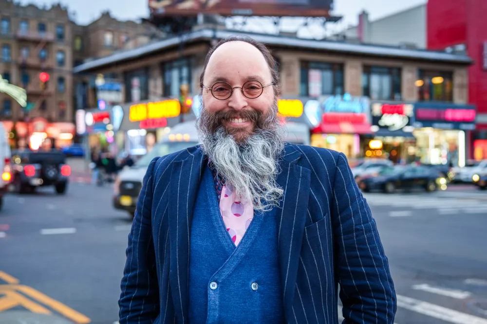 Giacomo Santangelo stands beside a busy NYC street crossing