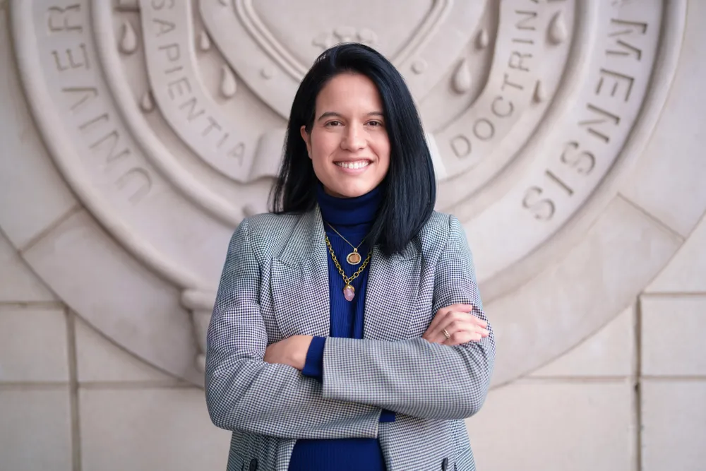 Carolina Villegas Galaviz stands in front of the Fordham Law School seal