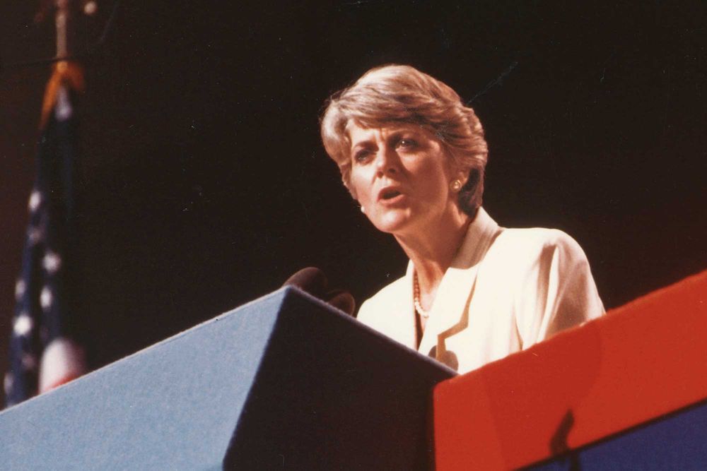 Geraldine Ferraro speaks at a podium at the Democratic National Convention
