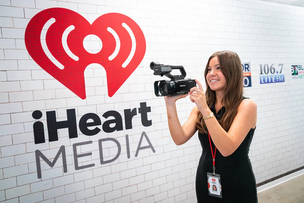 Stephanie Lane holding a camera at iHeartMedia studios