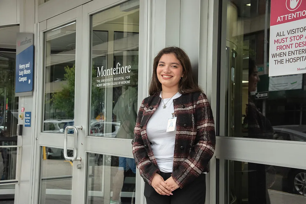 Julia Sosa standing in front of a Montefiore Health facility