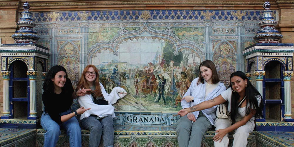students at a tile fountain in Granada, Spain