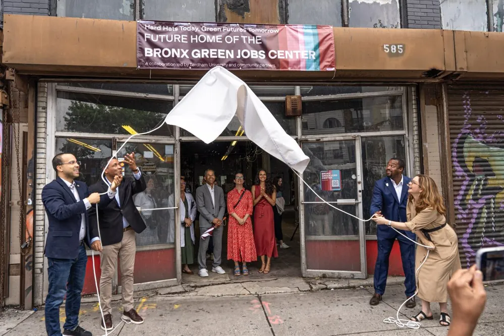 City officials and Fordham administrators unveil sign for the Bronx Green Jobs Center during groundbreaking event