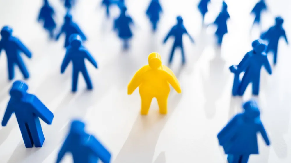 An illustration depicting a larger figure at the center of the image among smaller figure surrounding it.