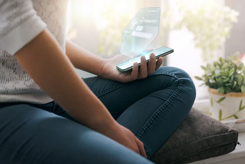 Close-up of a female patient interacting with an artificial intelligence counseling service, shown as a floating hologram originating from her mobile phone at home.