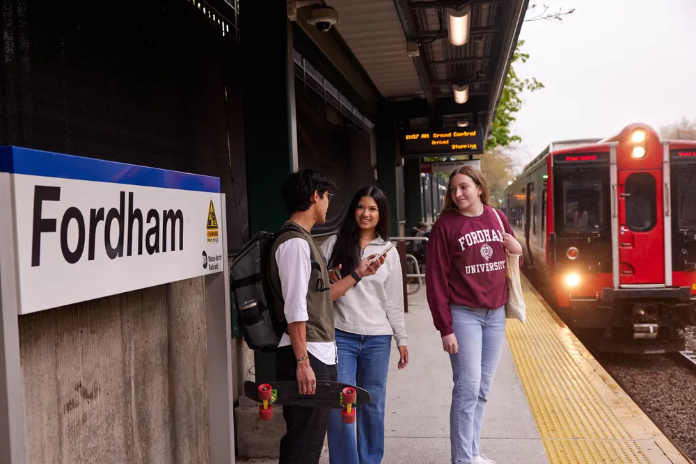 Three Fordham students waiting for a train to Gand Central