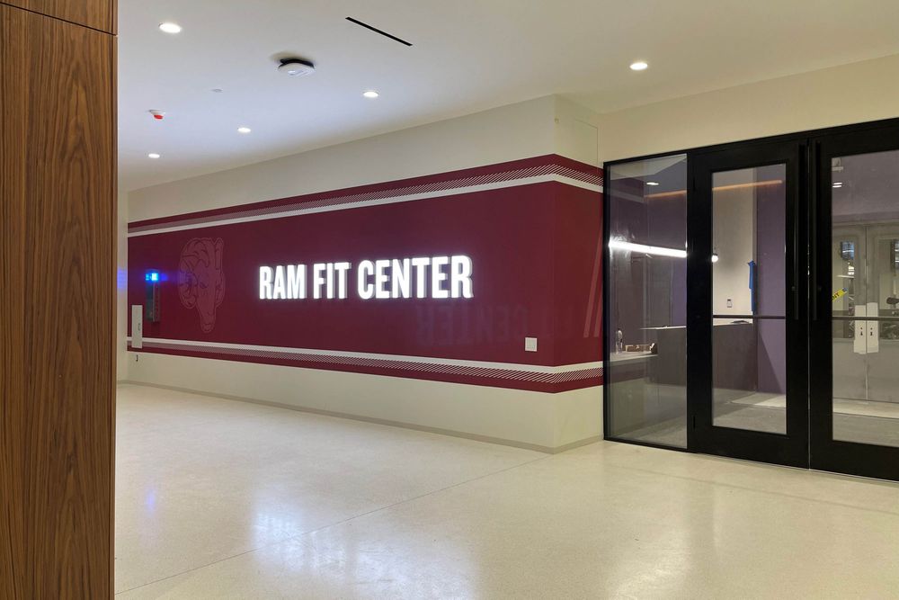 The illuminated sign at the entrance of the RamFit Center at Rose Hill