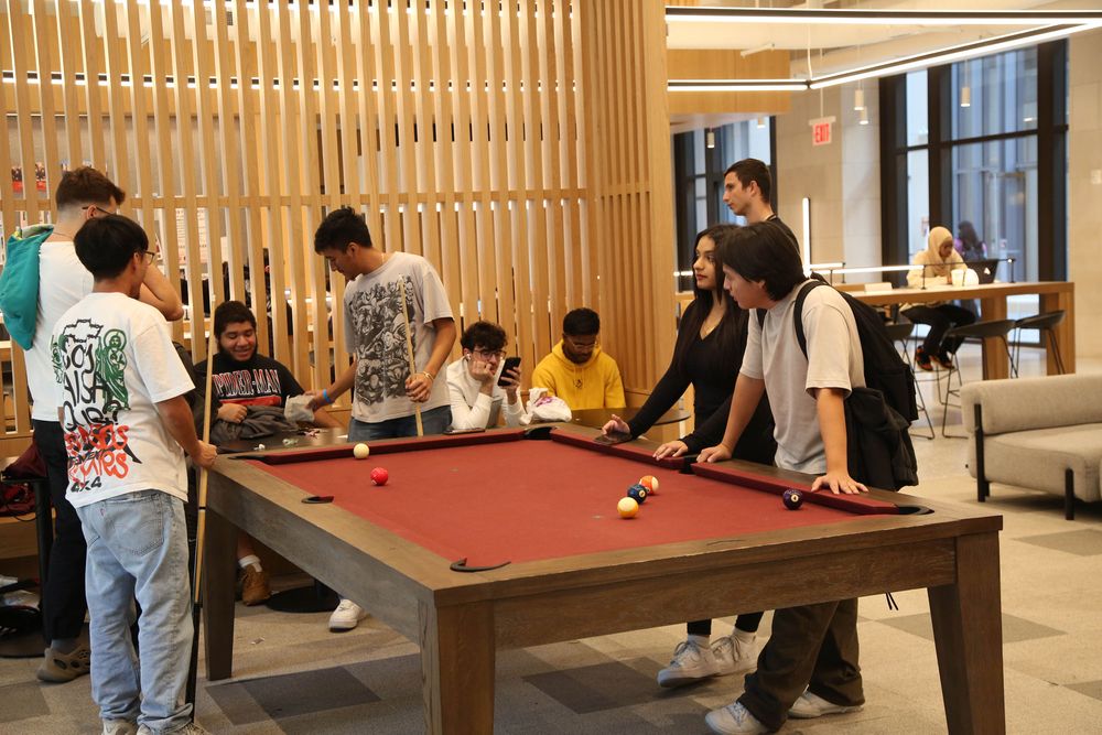 Students play pool in the McShane Center at Rose Hill