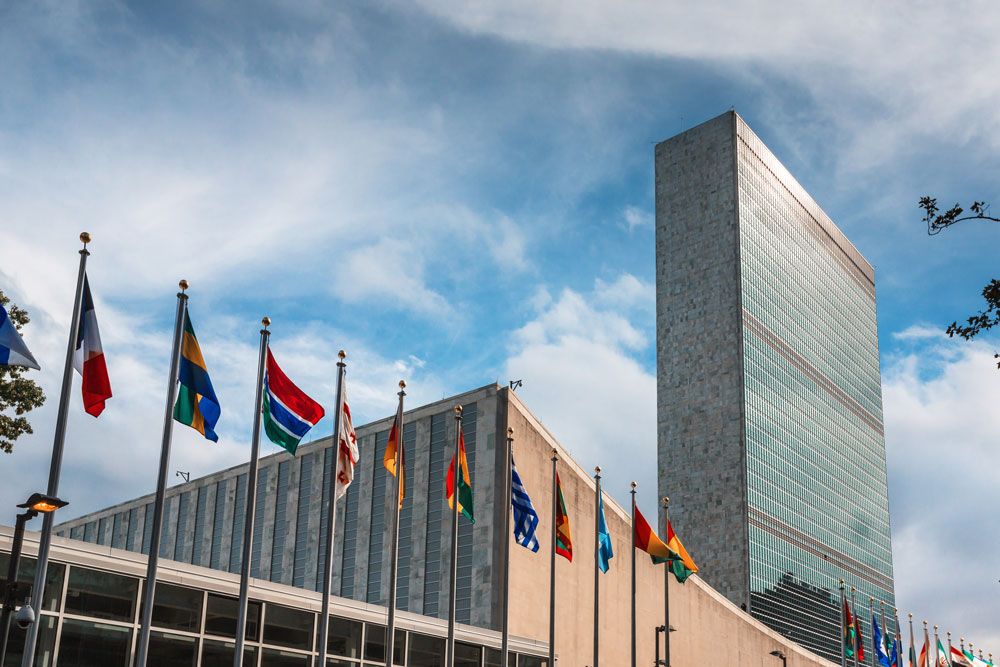 The exterior of the United Nations with international flags