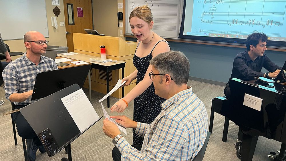 Fordham music major Sage Rochetti presents her music to the professional ensemble.