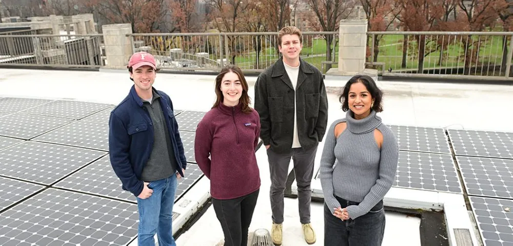 Sean Power, Amy Rini, Ethan Shepard, and Bhavika Yendapalli at Walsh Library, where solar panels have been generating electricity since 2010.