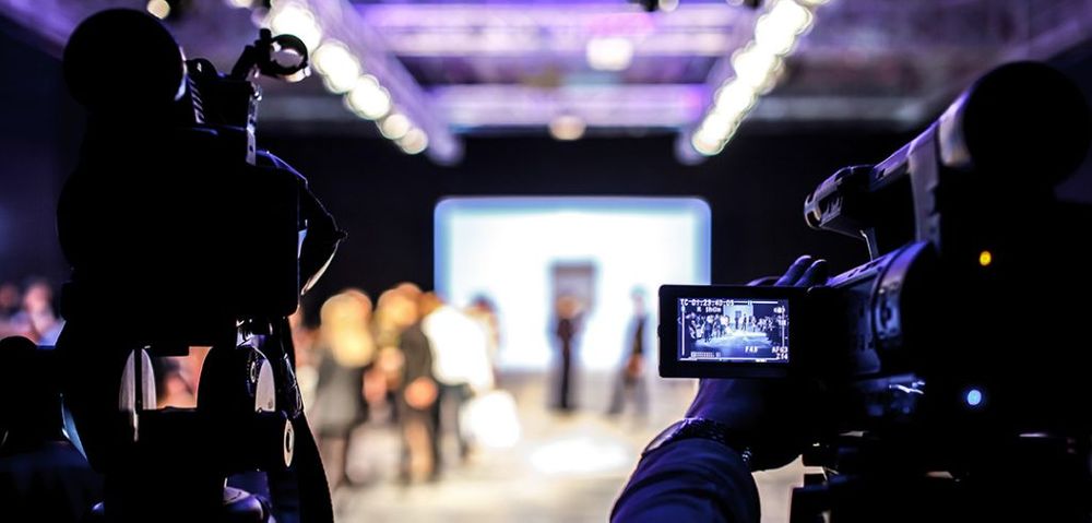 Looking through a video camera while filming in a studio
