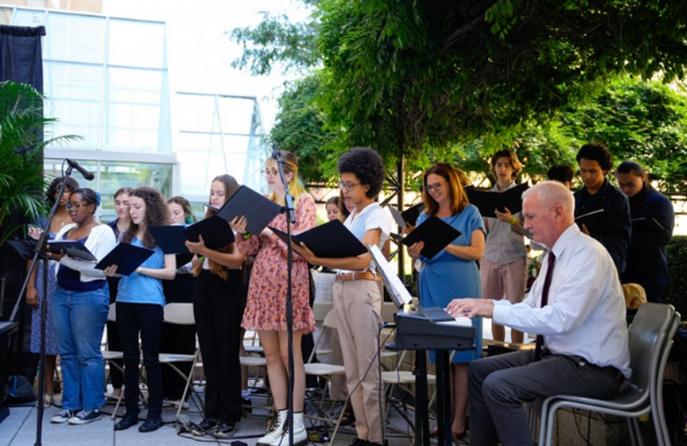 Student choir sings outdoors.