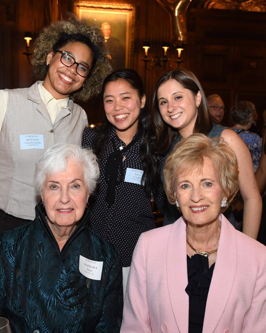 Two seated female donors with one male and two female scholarship recipients