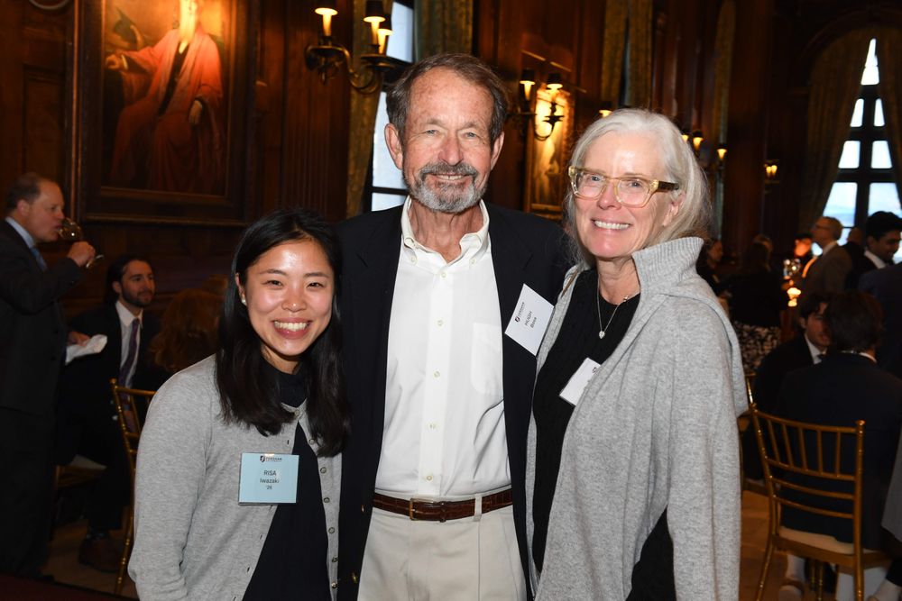 female student standing to the left of male and female donor