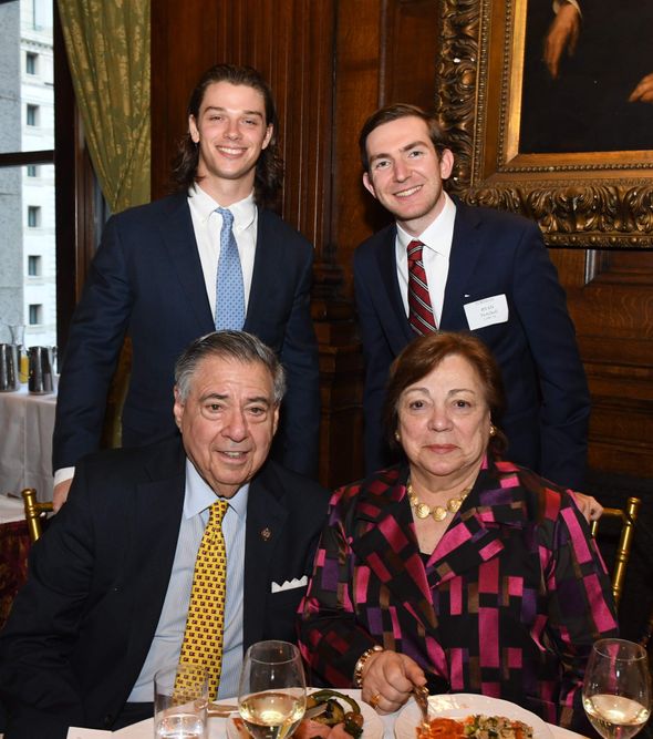 seated male and female donors with two male scholarship recipients