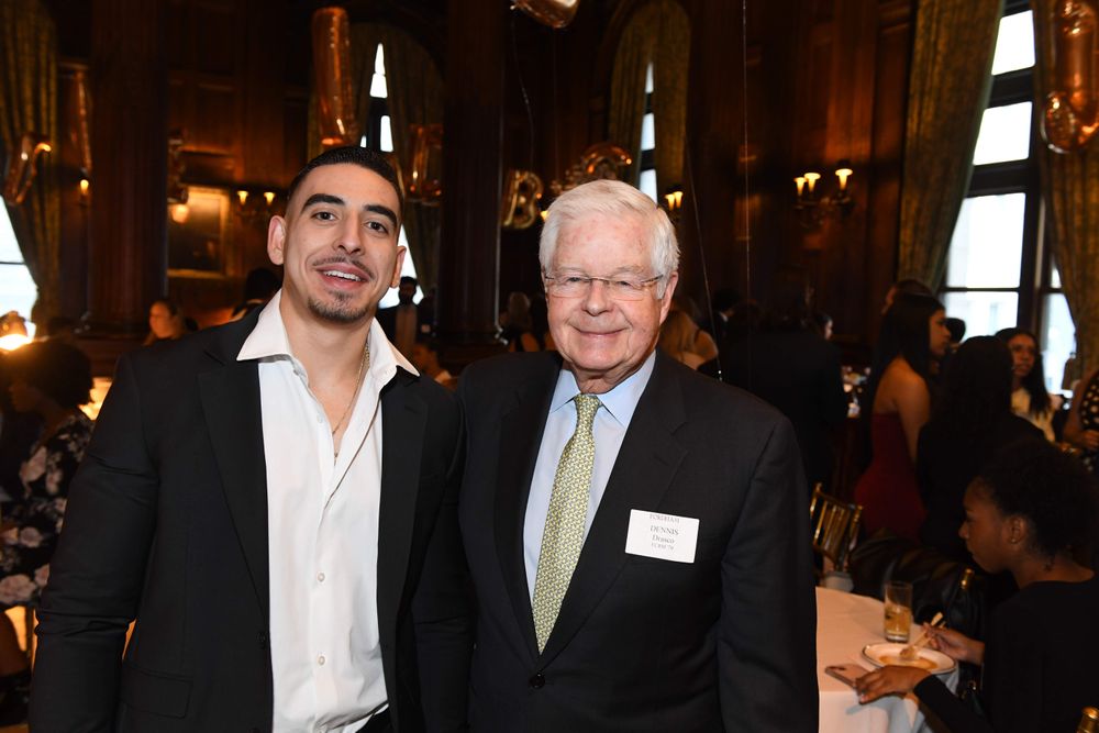 male scholar standing with male donor