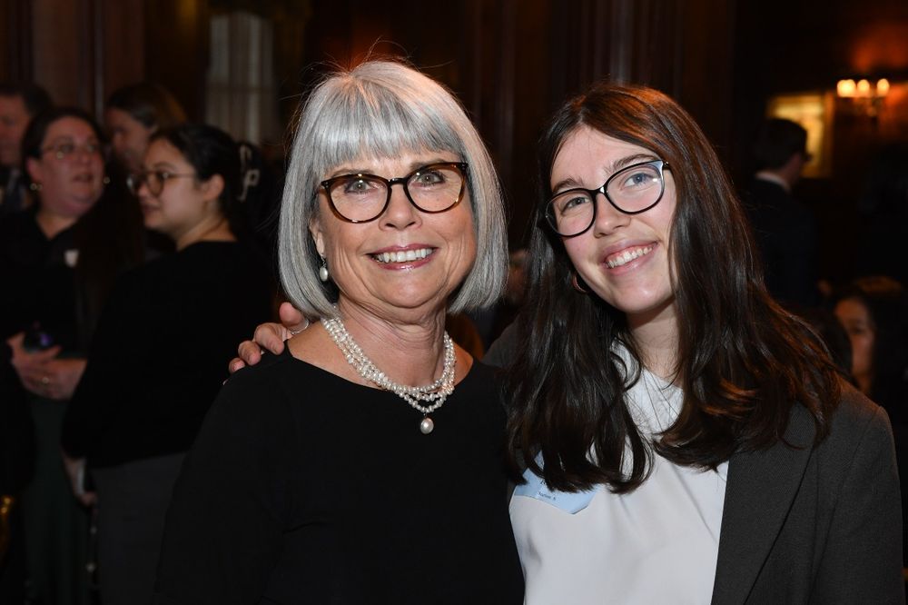 A white haired female donor wearing glasses stands next to a female student wearing glasses at the Scholarship Donors and Recipients Reception