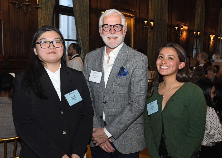 male donor stands between two female students