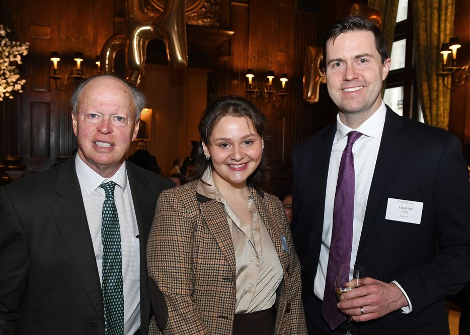 Two male donors stand with a female student at the Scholarship Donors and Recipients Reception