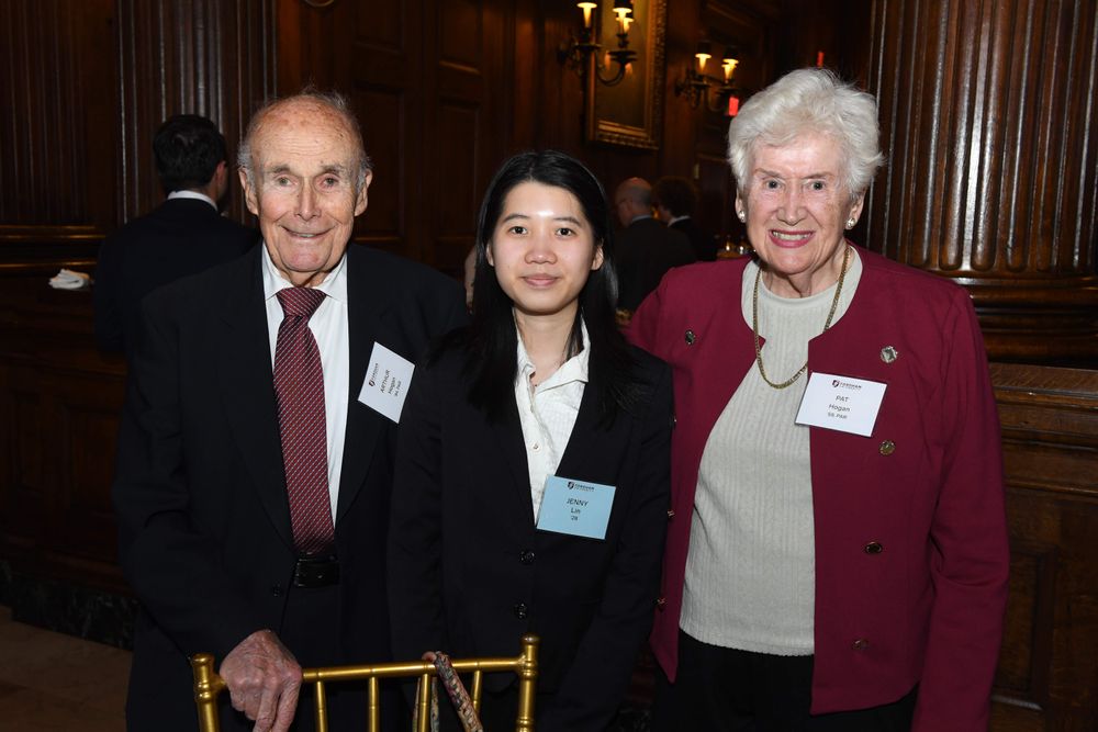 male and female donor stand on either side of female student