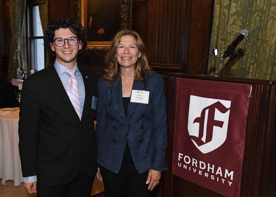 male student speaker standing with female trustee and donor