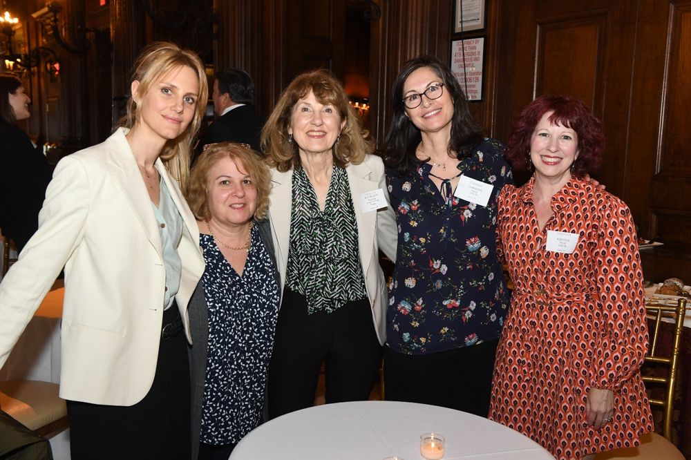 Female Donor stands with four female graduate students at the Scholarship Donors and Recipients Reception