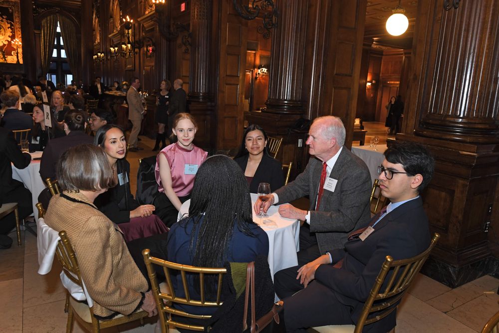 male and female donors sitting and conversing with scholars