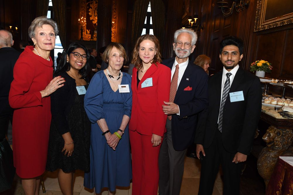 two female and one male donors standing with students