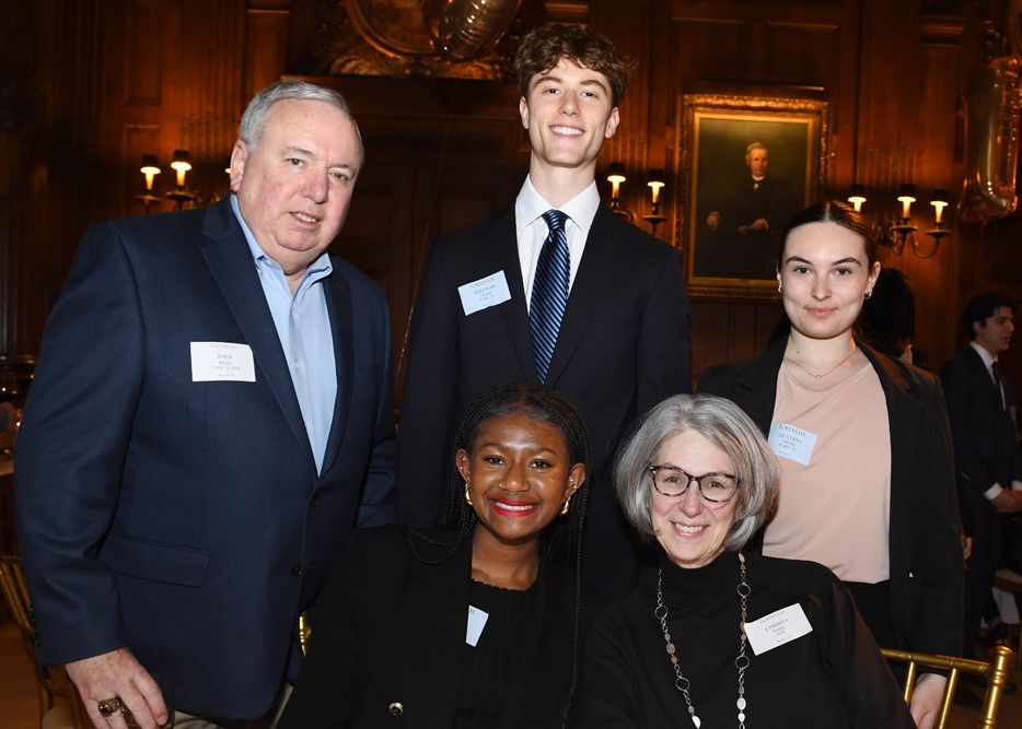 A male and female donor pose with two female students and a male student at the Scholarship Donors and Recipients Reception