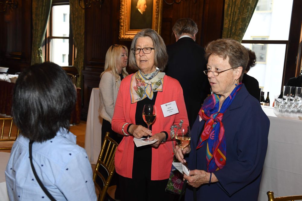 two female donors speaking with a student