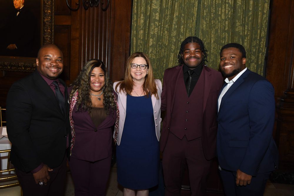 four family members with Fordham's president in the center