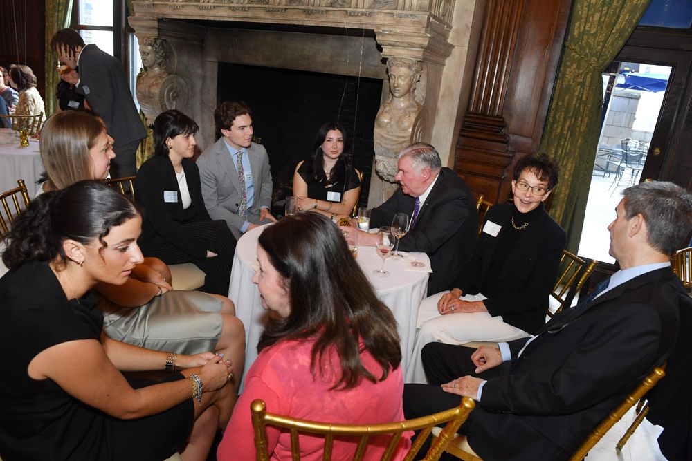 group of seated scholars with donors