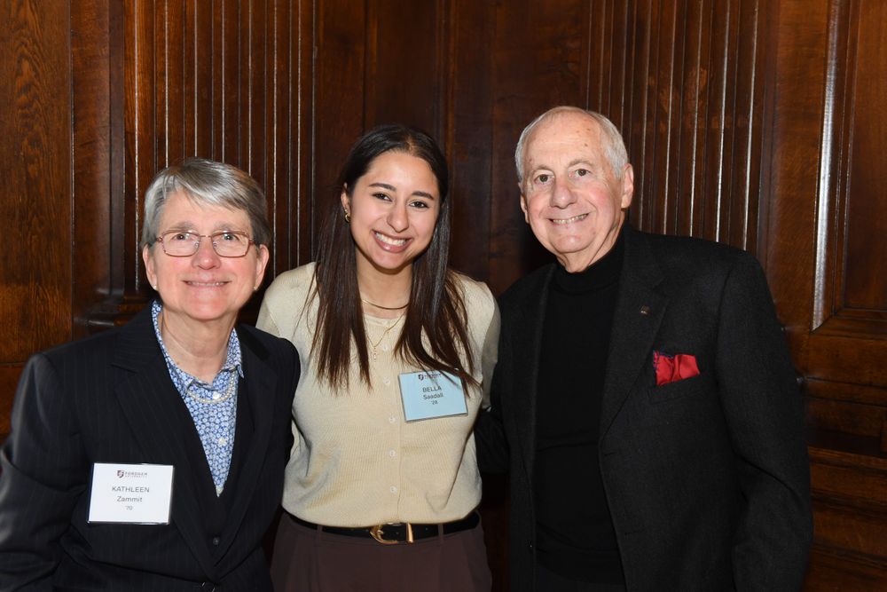 male and female donor stand on either side of female student